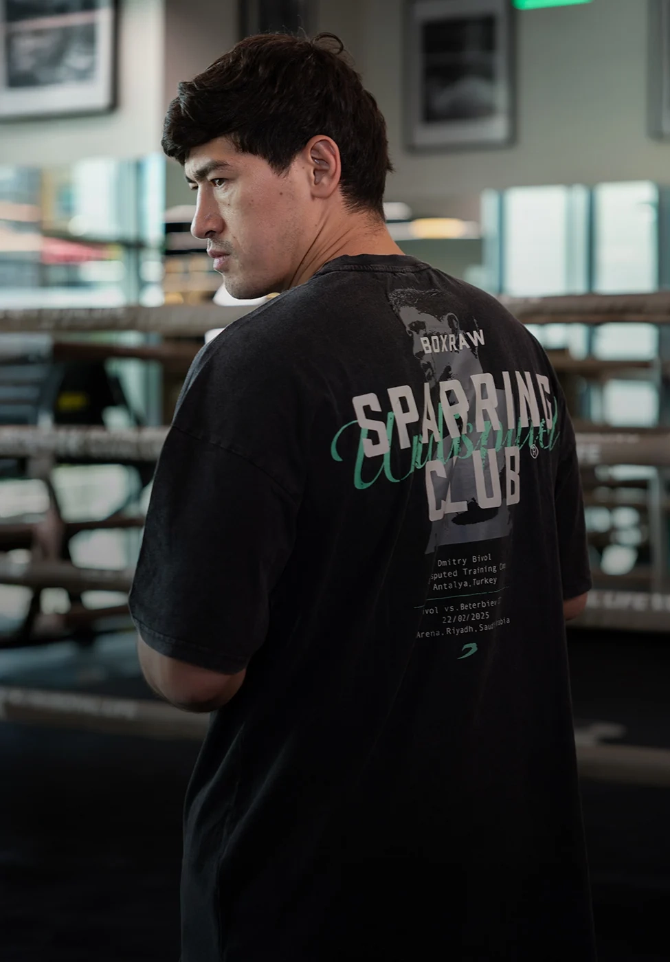 BOXRAW campaign still: a fighter in a dark Sparring Club T-shirt seen from behind